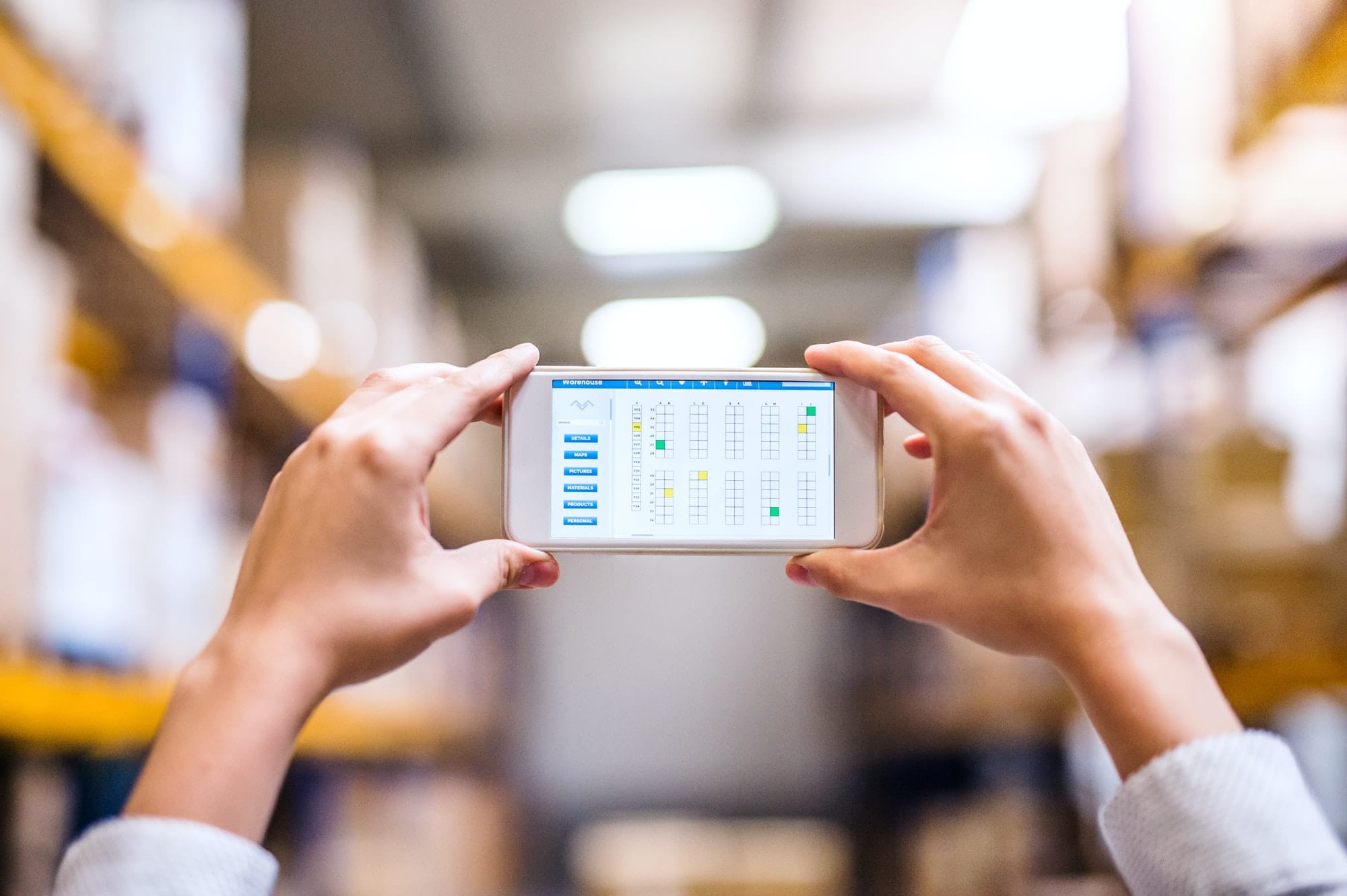 Home - woman warehouse worker with smartphone