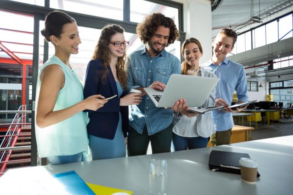 Alpion Connect - smiling business team discussing over laptop in meeting 600x400